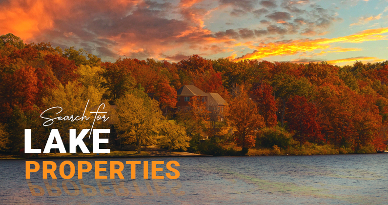 An image of a home near a lake in the middle of Autumn